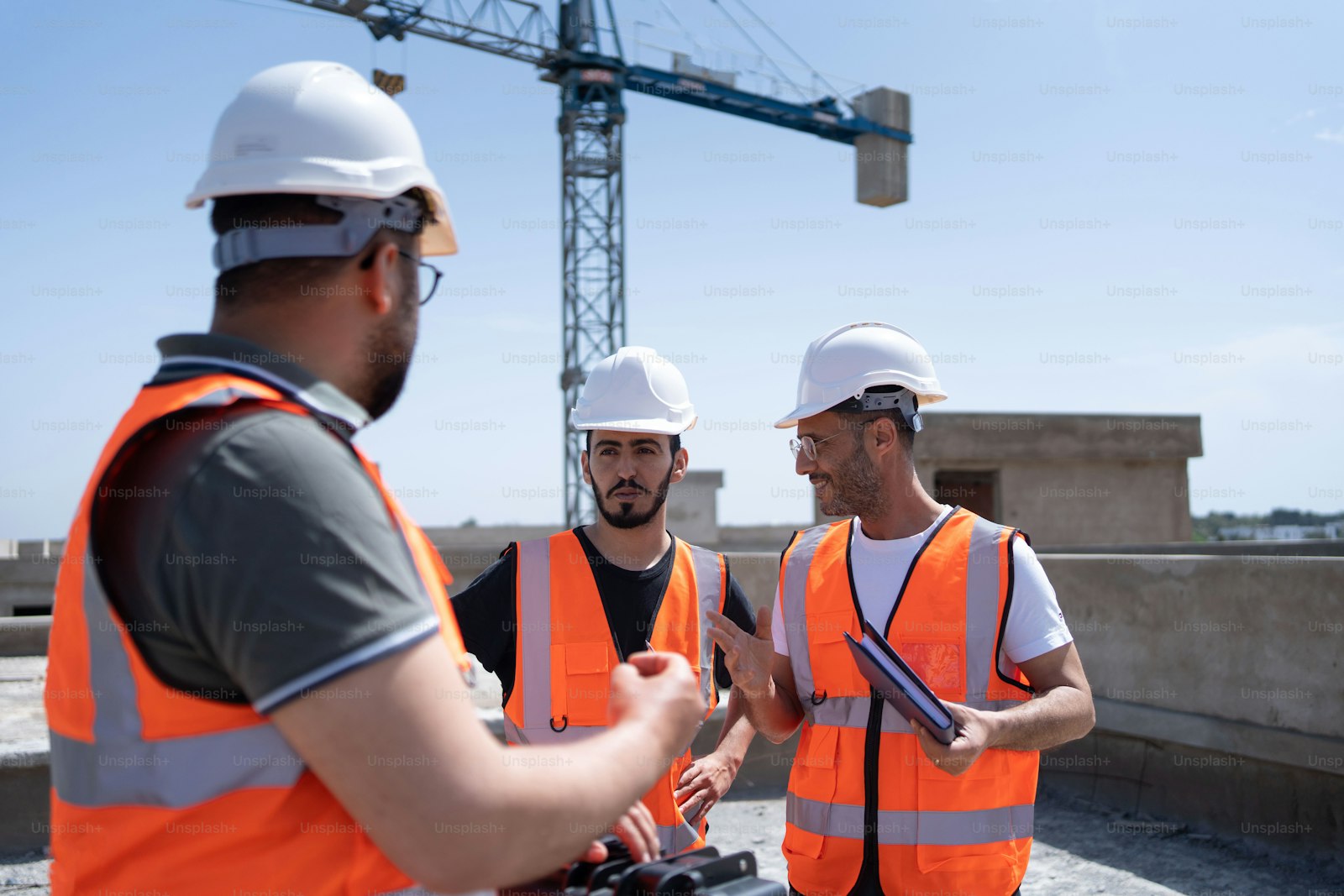 Construction workers discussing a project on site