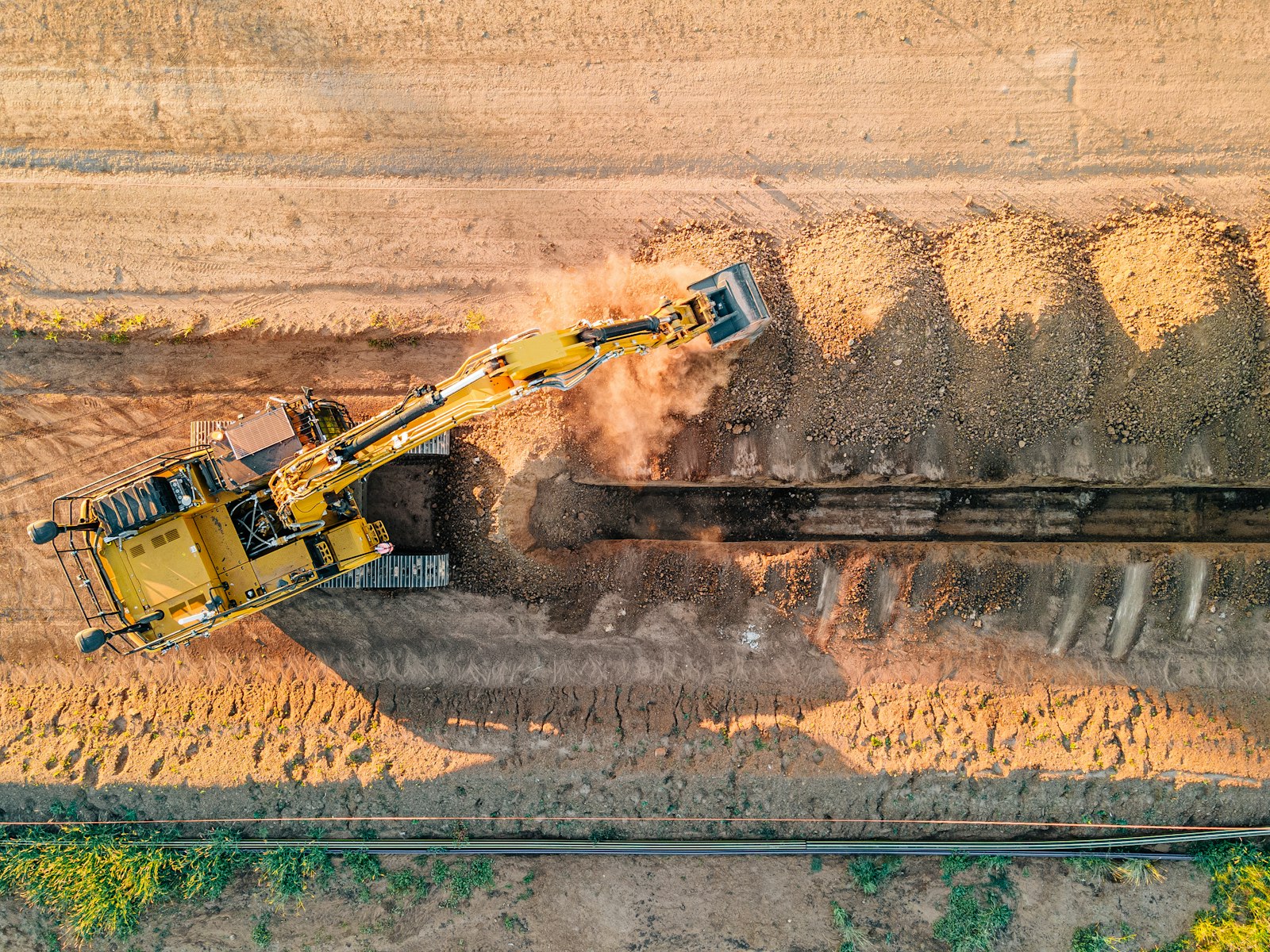 Yellow tipper truck on a dirt construction road